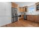 Modern kitchen featuring stainless steel refrigerator and microwave, and hardwood floors at 5113 Grice Ct, Charlotte, NC 28210