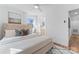 Bedroom featuring a tufted headboard, neutral bedding, and ensuite bathroom at 5113 Grice Ct, Charlotte, NC 28210