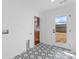 Clean, white mud room featuring hexagon tile flooring and a back door with windows at 5113 Grice Ct, Charlotte, NC 28210