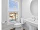 Clean bathroom with white pedestal sink, toilet and large window at 539 W Tremont Ave, Charlotte, NC 28203