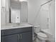 Bathroom with gray vanity and bathtub shower at 539 W Tremont Ave, Charlotte, NC 28203