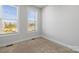 Well-lit bedroom with neutral carpeting and two windows at 539 W Tremont Ave, Charlotte, NC 28203