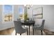 Dining room with hardwood floors, large windows, and art above the table at 539 W Tremont Ave, Charlotte, NC 28203