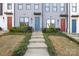 Three townhouses, gray siding, red and blue doors, small yards at 539 W Tremont Ave, Charlotte, NC 28203