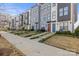 Row of townhouses, gray siding, red and blue doors, small yards at 539 W Tremont Ave, Charlotte, NC 28203