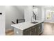 Kitchen island with sink, white quartz countertop, gray cabinets at 539 W Tremont Ave, Charlotte, NC 28203