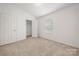 Bright bedroom with neutral carpeting and a spacious closet at 611 Cahill Ln, Fort Mill, SC 29715