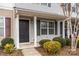 Townhome's front entrance with a dark gray door and surrounding bushes at 611 Cahill Ln, Fort Mill, SC 29715