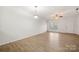 Living room with hardwood floors, ceiling fan, and door to outside at 611 Cahill Ln, Fort Mill, SC 29715