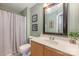 Bathroom with shower/tub combo, wood vanity, and framed art at 8044 Sapwood Ct, Matthews, NC 28104