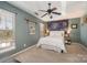 Bedroom with a tapestry, ceiling fan, and large windows at 8044 Sapwood Ct, Matthews, NC 28104