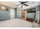 Main bedroom with large TV, ensuite bathroom access, and ceiling fan at 8044 Sapwood Ct, Matthews, NC 28104