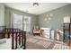 Bedroom with crib, changing table, and plenty of natural light at 8044 Sapwood Ct, Matthews, NC 28104