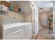 Laundry room with washer, dryer, and shelving for storage at 8044 Sapwood Ct, Matthews, NC 28104