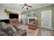 Living room with fireplace, wood floors, and TV at 8044 Sapwood Ct, Matthews, NC 28104