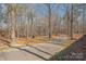 Paved walking trail winding through a wooded area with picnic tables at 8044 Sapwood Ct, Matthews, NC 28104