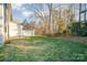 Landscaped backyard with grassy area and trees at 8146 Rudolph Rd, Charlotte, NC 28216