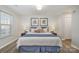 Main bedroom with king-size bed and window with blinds at 8146 Rudolph Rd, Charlotte, NC 28216