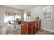 Bright dining area with a round table and four chairs, near sliding door access to backyard at 8146 Rudolph Rd, Charlotte, NC 28216