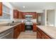 Modern kitchen with stainless steel appliances and wood cabinets at 8146 Rudolph Rd, Charlotte, NC 28216