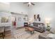 Open living room showcasing a fireplace and kitchen peek at 8146 Rudolph Rd, Charlotte, NC 28216