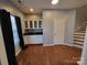 Finished basement area with hardwood floors, wet bar, and built-in shelving at 9323 Lenox Pointe Dr, Charlotte, NC 28273