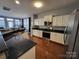 Spacious kitchen featuring white cabinets, granite countertops, and stainless steel appliances at 9323 Lenox Pointe Dr, Charlotte, NC 28273