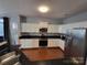 Modern kitchen with white cabinets, granite countertops, and stainless steel appliances at 9323 Lenox Pointe Dr, Charlotte, NC 28273