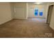 Spacious carpeted bedroom with large windows and neutral walls at 10028 Nw Trailhead Nw Way, Huntersville, NC 28078