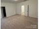 Spacious carpeted bedroom with access to bathroom at 10028 Nw Trailhead Nw Way, Huntersville, NC 28078