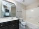 Bathroom with dark vanity, shower/tub combo, and tile floors at 104 Pratt St, Belmont, NC 28012