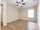 Bright bedroom featuring hardwood floors and ceiling fan at 104 Pratt St, Belmont, NC 28012