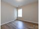 Simple bedroom with hardwood floors and a window at 104 Pratt St, Belmont, NC 28012