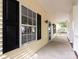 Front porch with white railing and black shutters at 104 Pratt St, Belmont, NC 28012