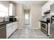 Kitchen with white cabinets, black countertops, and stainless steel appliances at 104 Pratt St, Belmont, NC 28012