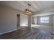 Dining room with wood-look flooring and a modern light fixture at 10502 Haddington Nw Dr, Charlotte, NC 28269