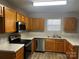 Kitchen with wood cabinets, stainless steel appliances, and light countertops at 10502 Haddington Nw Dr, Charlotte, NC 28269