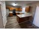 Kitchen boasts wood cabinets, an island, and stainless steel appliances at 10502 Haddington Nw Dr, Charlotte, NC 28269