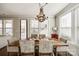 Dining room with a rustic wooden table and chandelier, adjacent to kitchen at 12014 Grey Partridge Dr, Charlotte, NC 28278