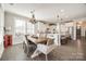 Bright dining area with a wooden table and chairs, open to kitchen at 12014 Grey Partridge Dr, Charlotte, NC 28278