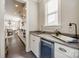 Modern kitchen with white cabinets, wine cooler, and granite countertops at 12014 Grey Partridge Dr, Charlotte, NC 28278