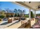 Covered patio with comfortable seating, firepit and pergola at 12014 Grey Partridge Dr, Charlotte, NC 28278