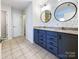 Double vanity bathroom with blue cabinets and floral wallpaper at 14916 Oregon Oak Ct, Mint Hill, NC 28227