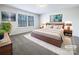 Large bedroom with plush carpeting and virtually staged furnishings at 14916 Oregon Oak Ct, Mint Hill, NC 28227