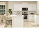 Modern kitchen island with white quartz countertops and woven barstools at 1811 Otter Perch Ln, Fort Mill, SC 29715