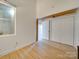 Simple bedroom with hardwood floors and closet at 201 S Hoskins Rd # 122, Charlotte, NC 28208