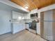 Modern kitchen with stainless steel appliances and wood ceiling at 201 S Hoskins Rd # 122, Charlotte, NC 28208