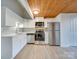 Modern kitchen with white cabinets and stainless steel appliances at 201 S Hoskins Rd # 122, Charlotte, NC 28208