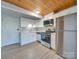 Modern kitchen with stainless steel appliances and wood ceiling at 201 S Hoskins Rd # 122, Charlotte, NC 28208