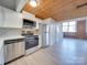 Modern kitchen with stainless steel appliances and wood ceiling at 201 S Hoskins Rd # 122, Charlotte, NC 28208